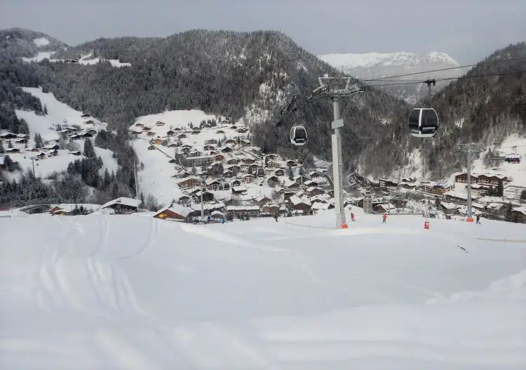 Efficient gondolas move the throng of skiers out of the La Clusaz village.