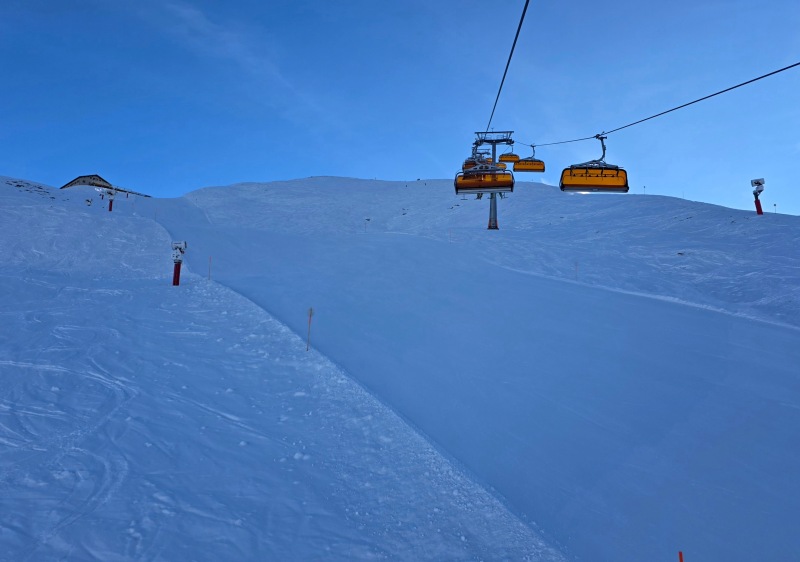 Empty piste under Sonnen chair in early morning shade