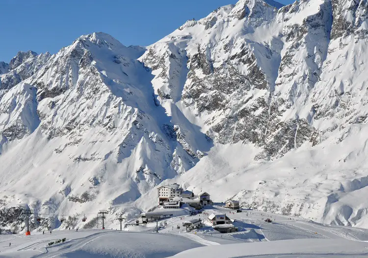 Plan Maison mid-mountain station stands tiny against the Alps at Cervinia ski resort