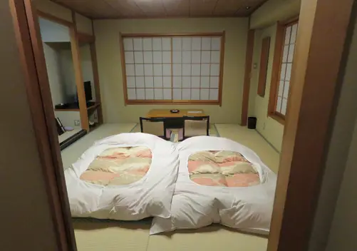 Japanese style room with futons on the tatami floor